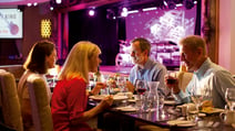 A group of guests in the Grove cabaret restaurant at Alvaston Hall enjoying their meal and waiting for the entertainment to appear on the stage in the background