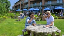 Guests enjoying beers on the Arden terrace at Studley Castle Hotel