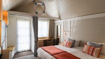 The bedroom inside a Clifftop Lodge Chalet at Corton.