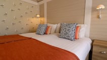 Bedroom inside a Clifftop Lodge at Corton