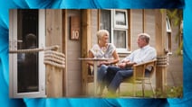 A couple enjoying a drink together on the balcony of their Bay Cottage at Lakeside, a Warner Village. The border depicts the soft furnishings found within the thoughtfully designed chalets and cottages.