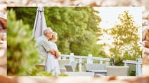 A couple enjoying a tranquil moment together enjoying the view of the Solent at Norton Grange, a Warner Village. The border depicts the pebbly beach found nearby.