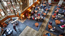 An aerial view of the Great Hall at Thoresby Hall Hotel, where there is an entertainer performing to many guests