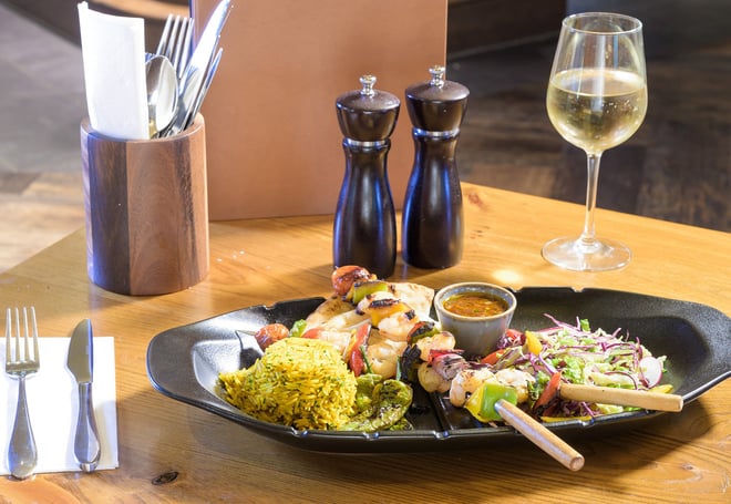 Delicious skewers on a table served within The Travelling Duke restaurant at Heythrop Park