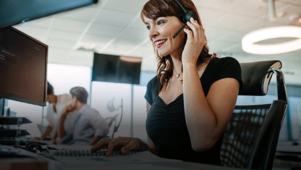 Office setting with a woman wearing a headset at Warner Contact Center.