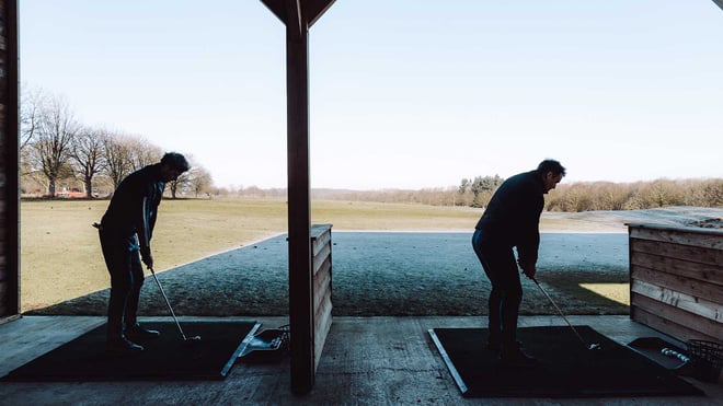 Guests practising swings in driving range