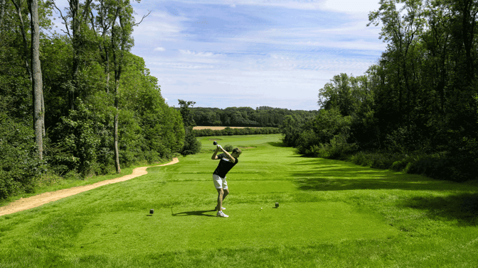 Man taking a swing on the golf course