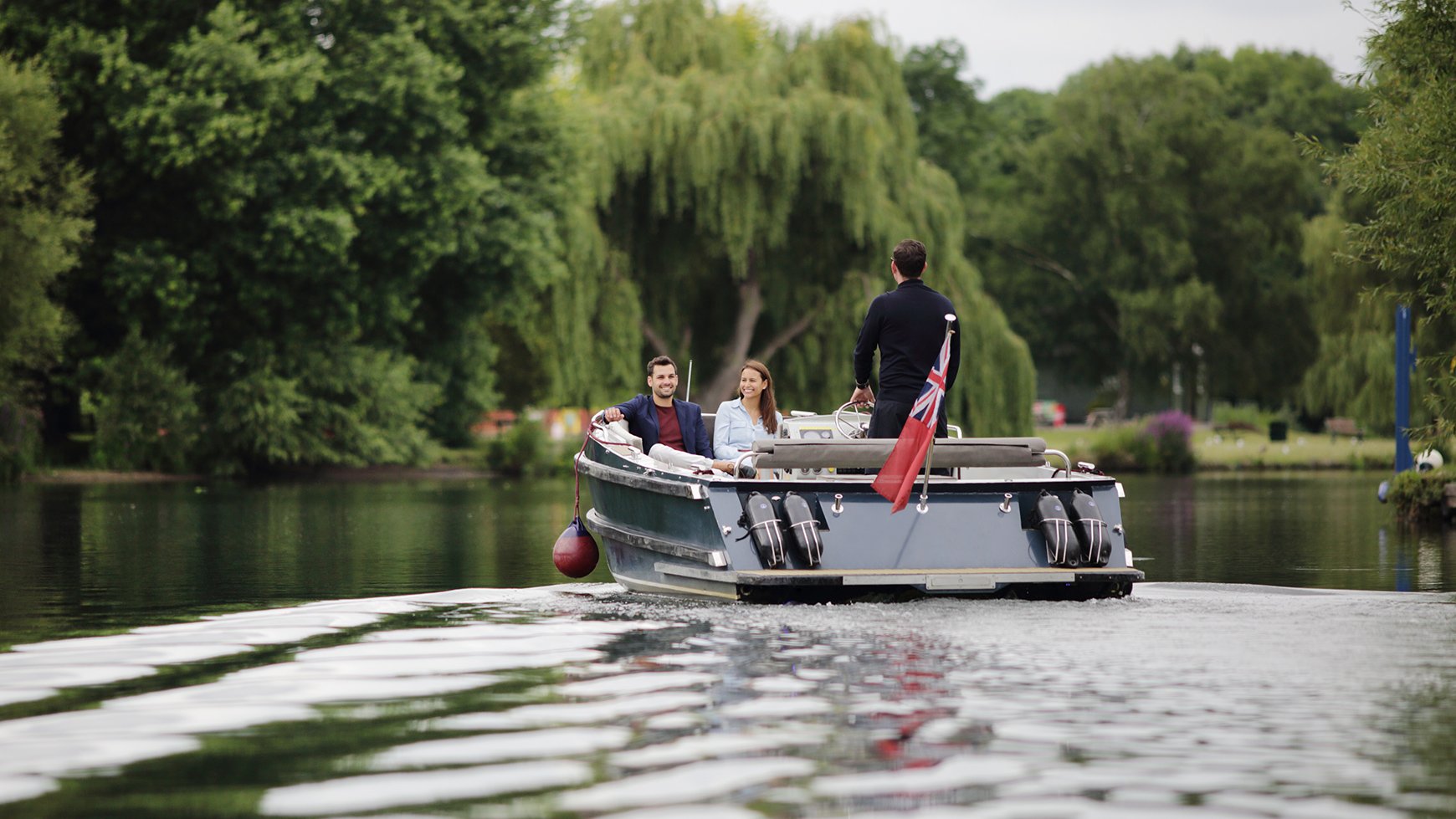 Two guests staying at The Runnymede on Thames enjoying a boat cruise along the River Thames